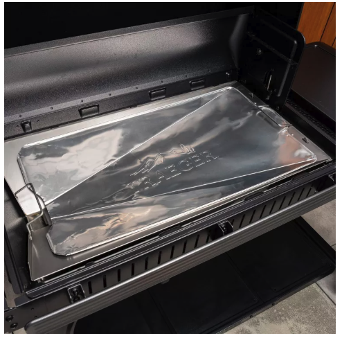 Grill with protective liner in bottom