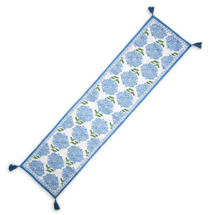 Floral patterned table runner with blue flowers on a white background