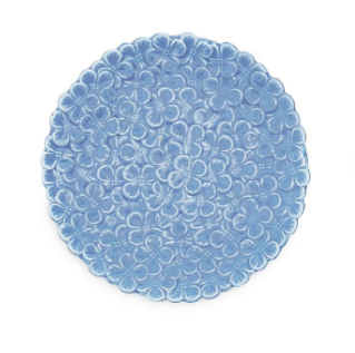 Round blue trivet with floral pattern on a white background