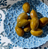 Olives on a blue decorative plate with floral patterns