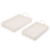 Two beige baskets with white handles on a white background