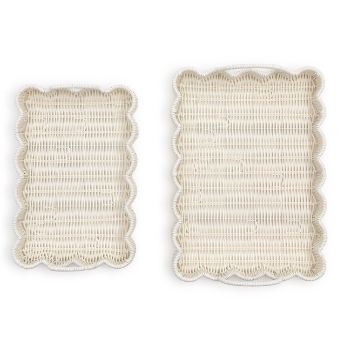 Two beige scalloped placemats on a white background