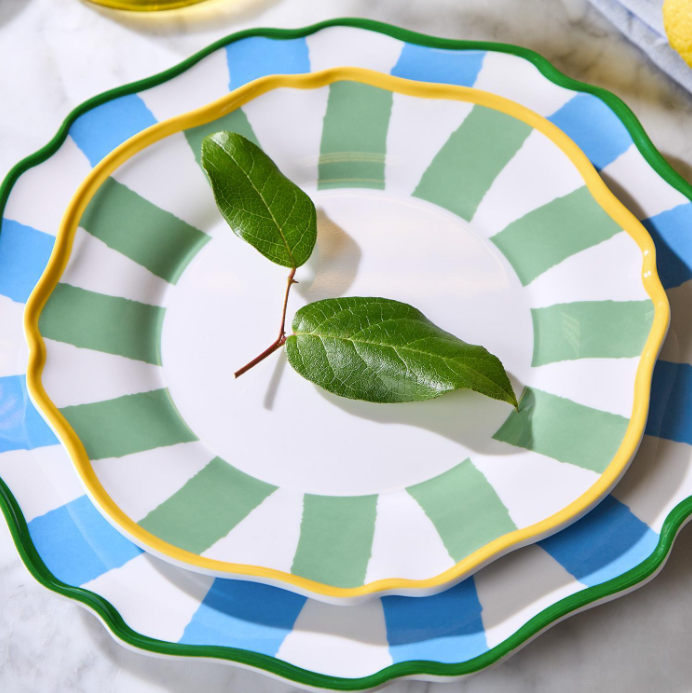 Decorative plates with green leaf on a marble surface