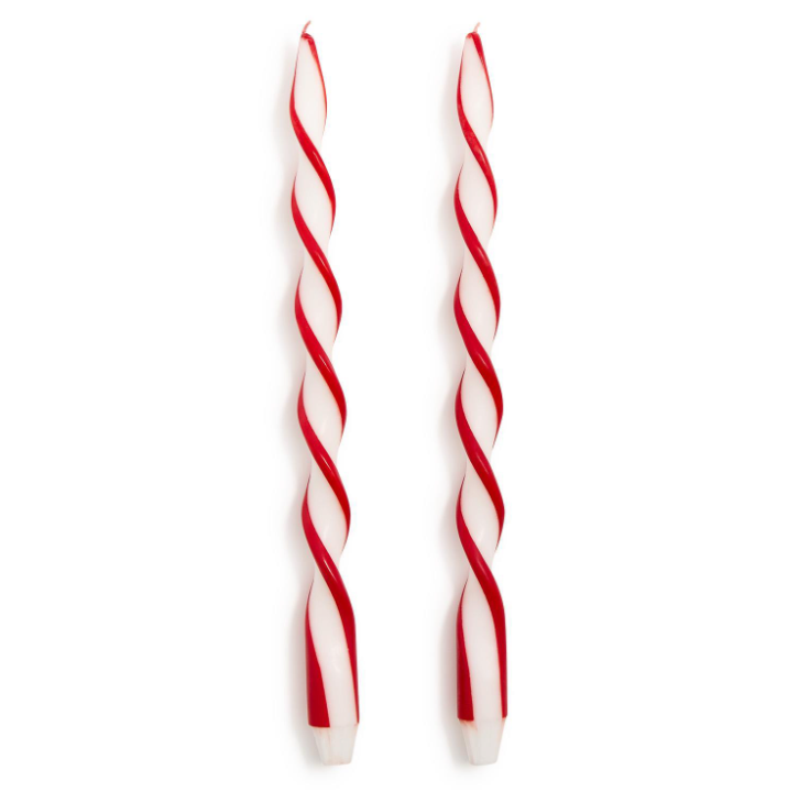 Two red and white striped candles on a white background