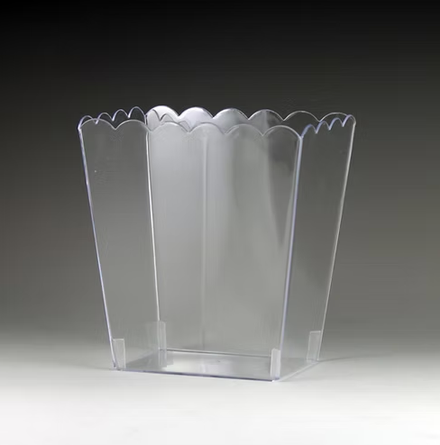 Clear scalloped edge container on a dark background