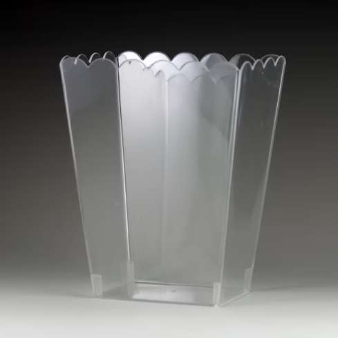 Clear scalloped edge container on a dark background