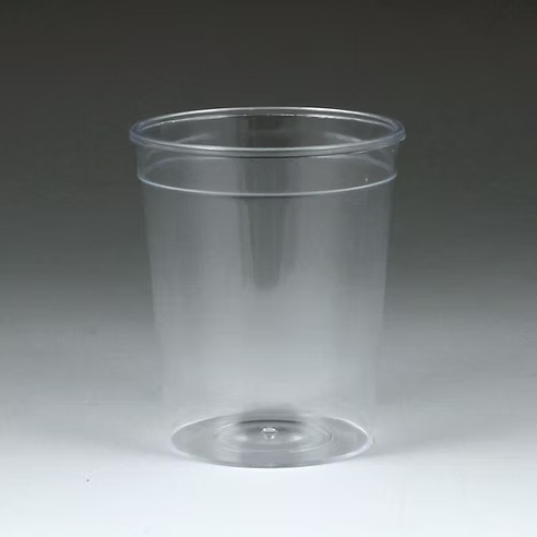 Clear plastic cup on a gray background