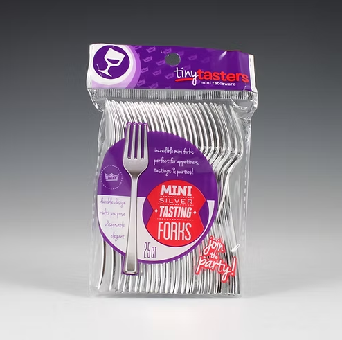 Pack of mini silver tasting forks with purple packaging on a gray background