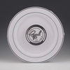 Round white plastic plate with silver trim and 'Regal' branding on a gray background