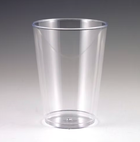 Clear plastic cup on a gray background