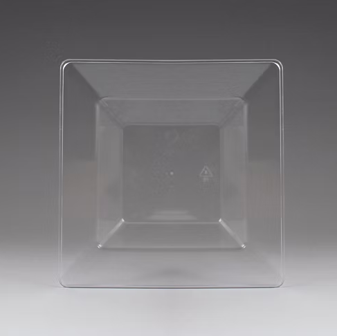 Clear square plastic bowl on a gray background