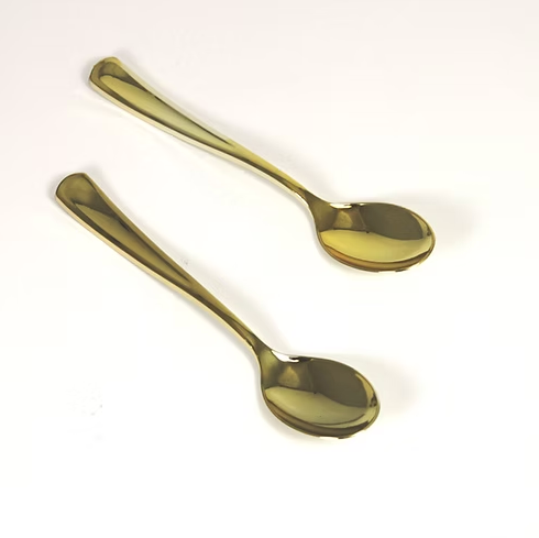 Two gold spoons on a white background