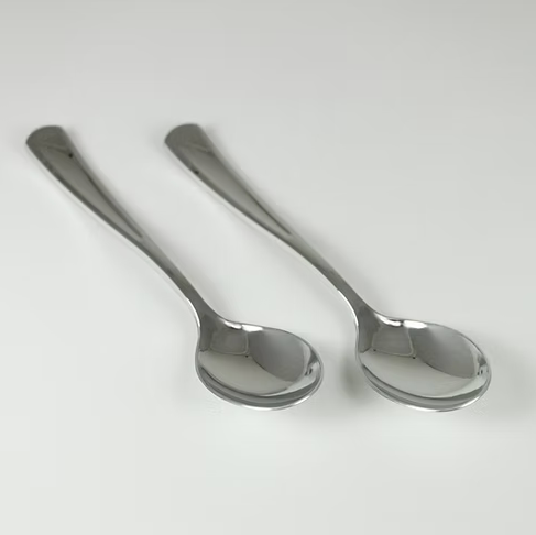 Two silver spoons on a white background