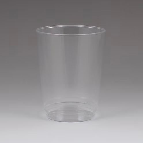 Clear plastic cup on a gray background