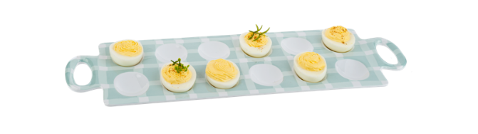 Deviled eggs on a decorative tray with a white background