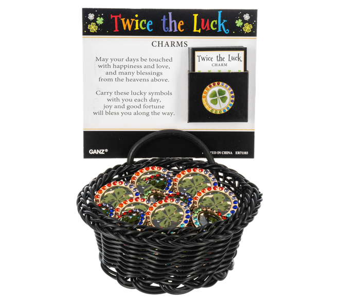 Twice the Luck charms in a black basket with packaging on a white background