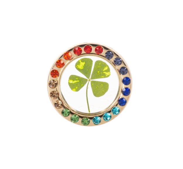 Four-leaf clover charm with colorful gemstones on a white background
