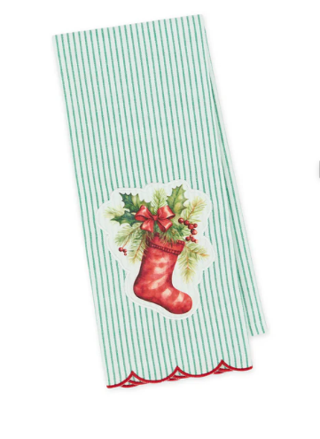 A rectangular kitchen towel with thin green and white vertical stripes, featuring a vintage-style red Christmas stocking graphic with holly and a red bow, finished with a red scalloped edge.
