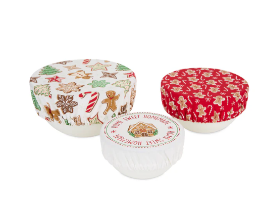 Three bowls with holiday themed fabric bowl covers. 