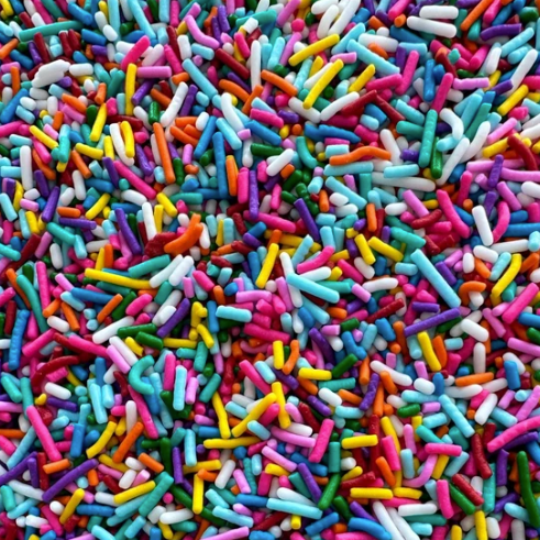 A close-up view of colorful candy sprinkles in multiple colors.