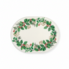 An oval paper platter with a green holly and berry wreath pattern around the rim, shown on a white background.