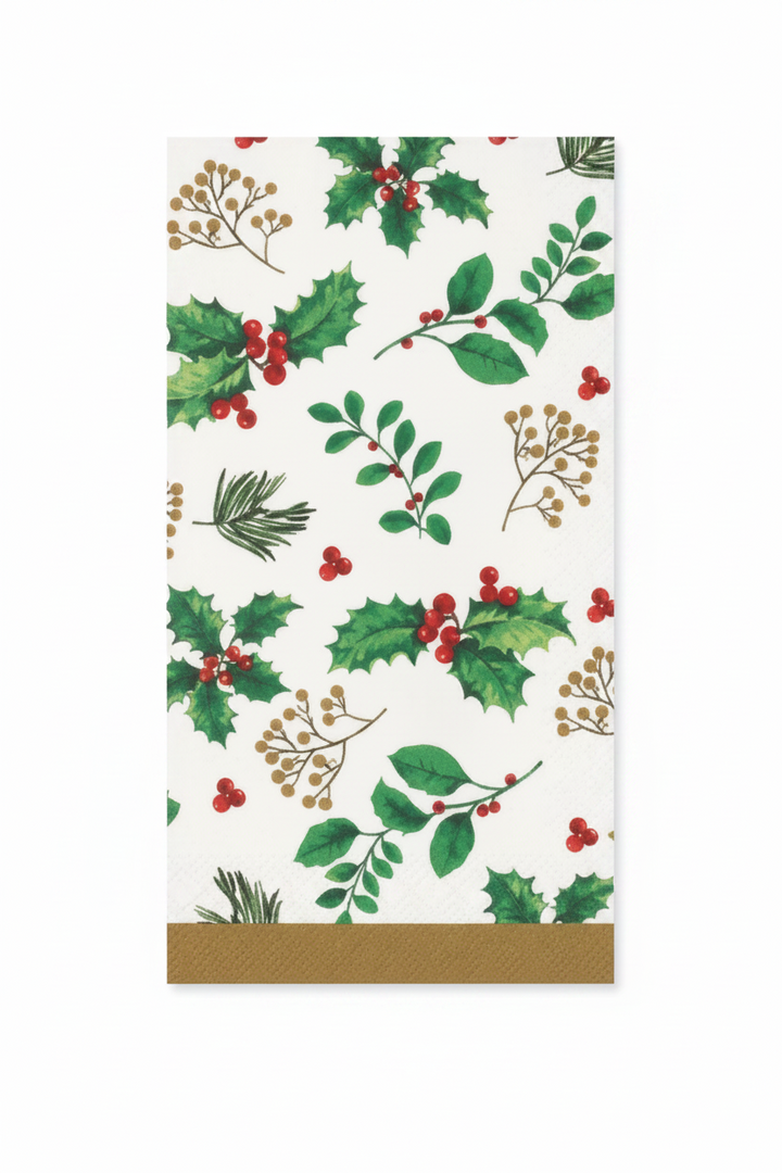 A white napkin printed with a festive holly and berry pattern, featuring green leaves, red berries, and gold decorative borders at the bottom.