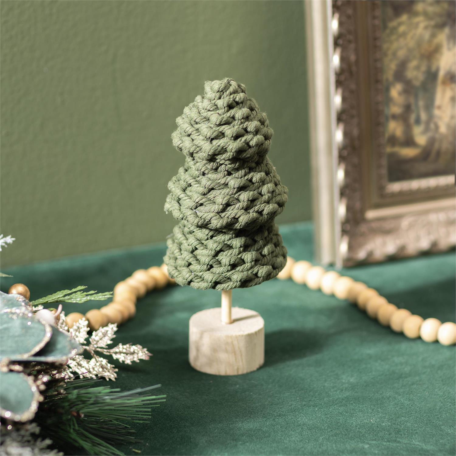 Green fabric tree on a wooden base with a green background