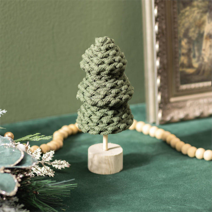 Green fabric tree on a wooden base with a green background