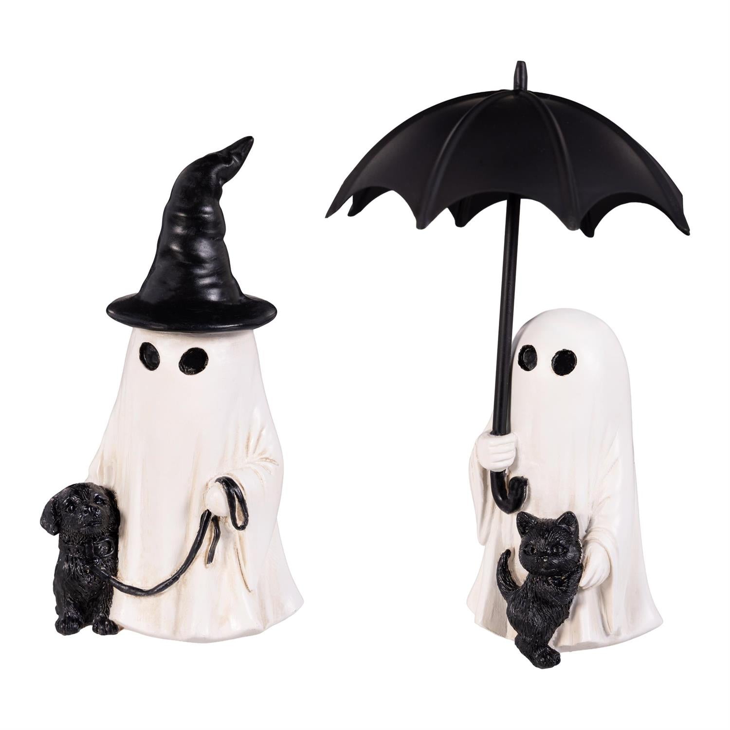 Two small figurines of ghosts with a black hat, umbrella and a cat and dog on a wooden surface.