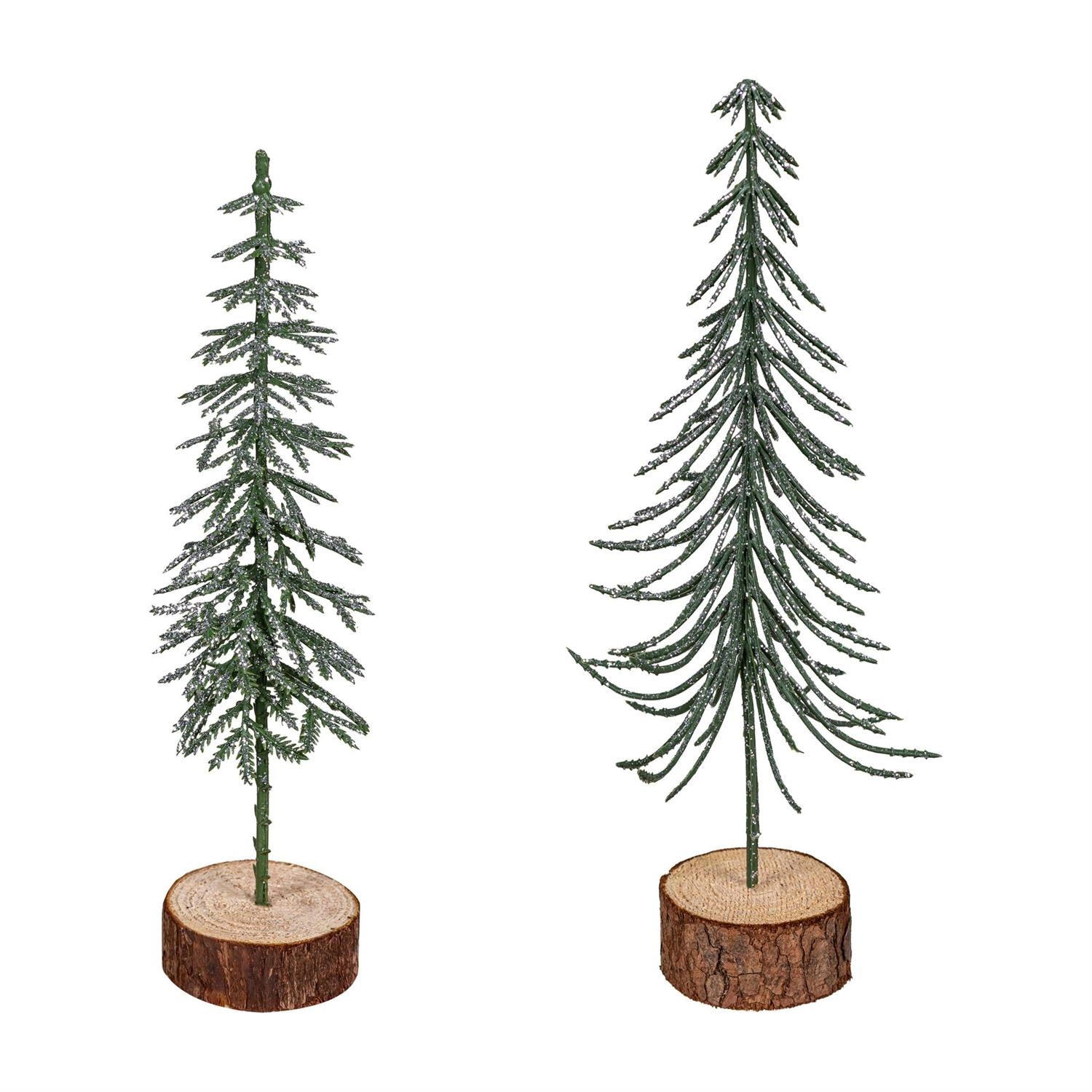 Two miniature Christmas trees on wooden bases against a white background