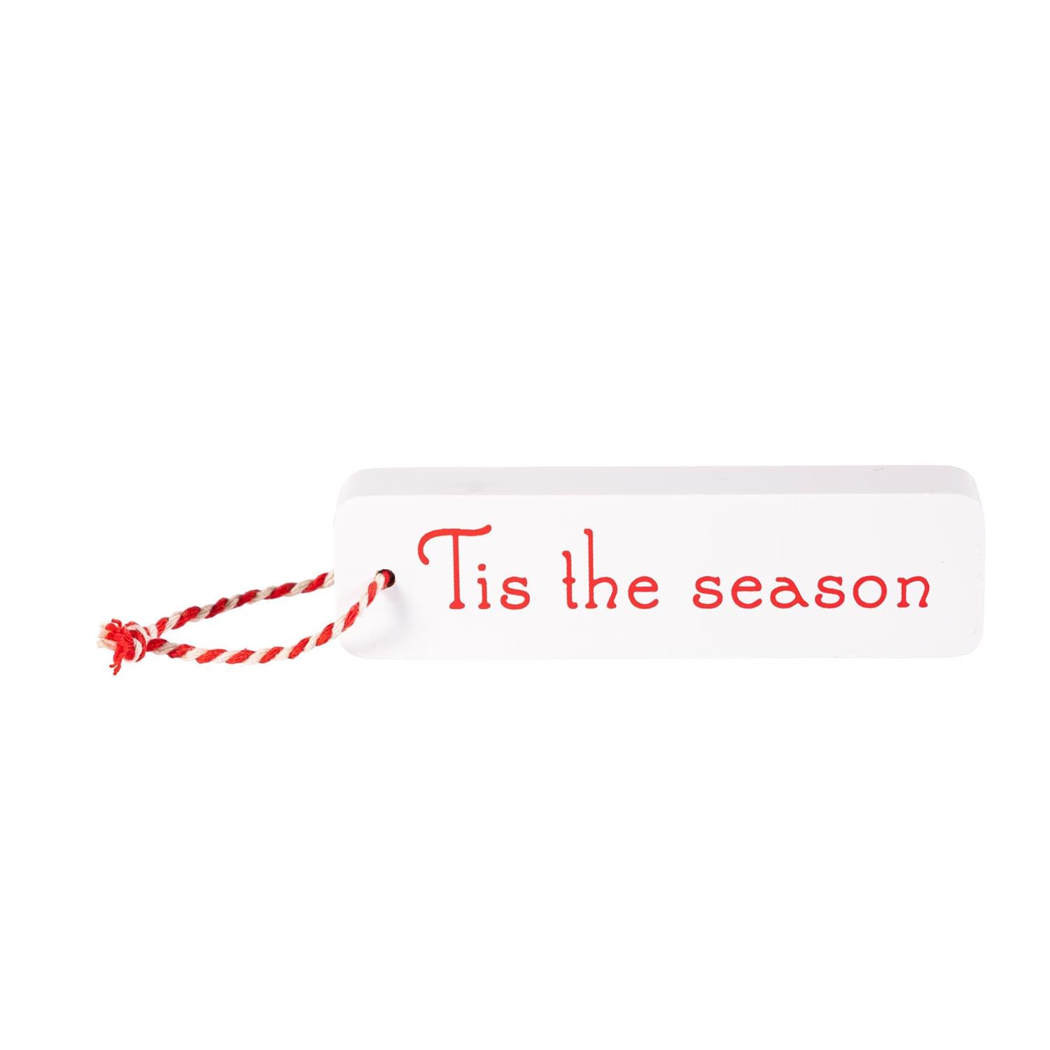 White sign with red 'Tis the season' text and red string on a white background
