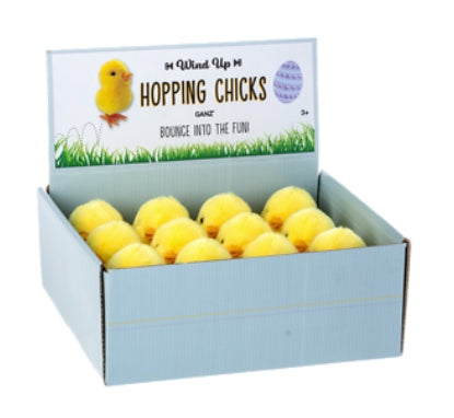 Box of wind-up hopping chicks on a white background