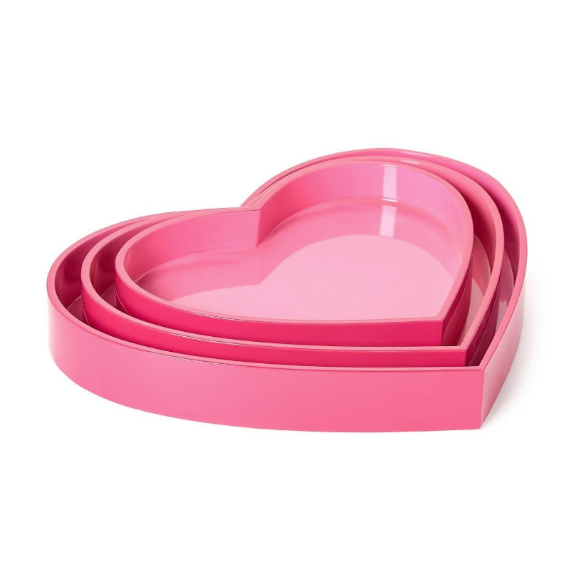 Set of three pink heart-shaped trays on a white background