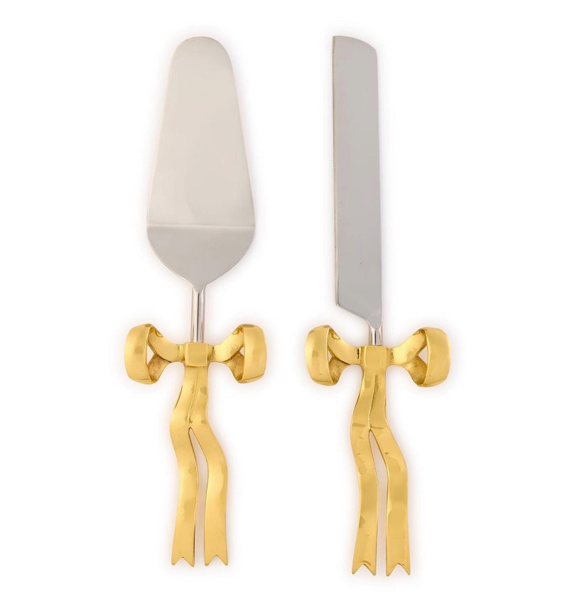 Set of cake server and knife with gold bow accents on a white background