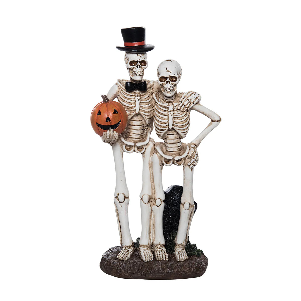 Skeleton couple figurine holding a pumpkin on a white background