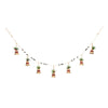 Decorative garland with bells and holly greenery and berries on a white background