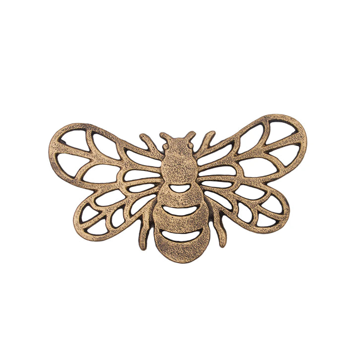 Bronze bee-shaped decorative trivet on a white background