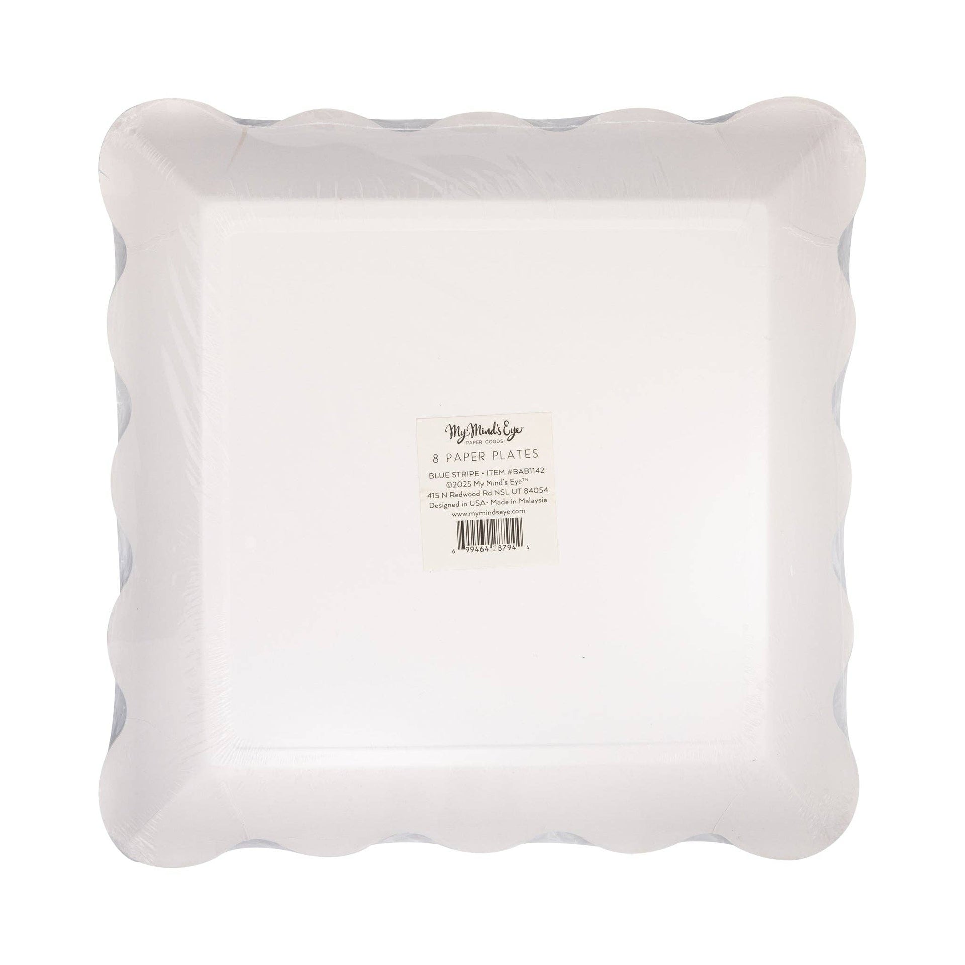 White paper plates with scalloped edge on a white background