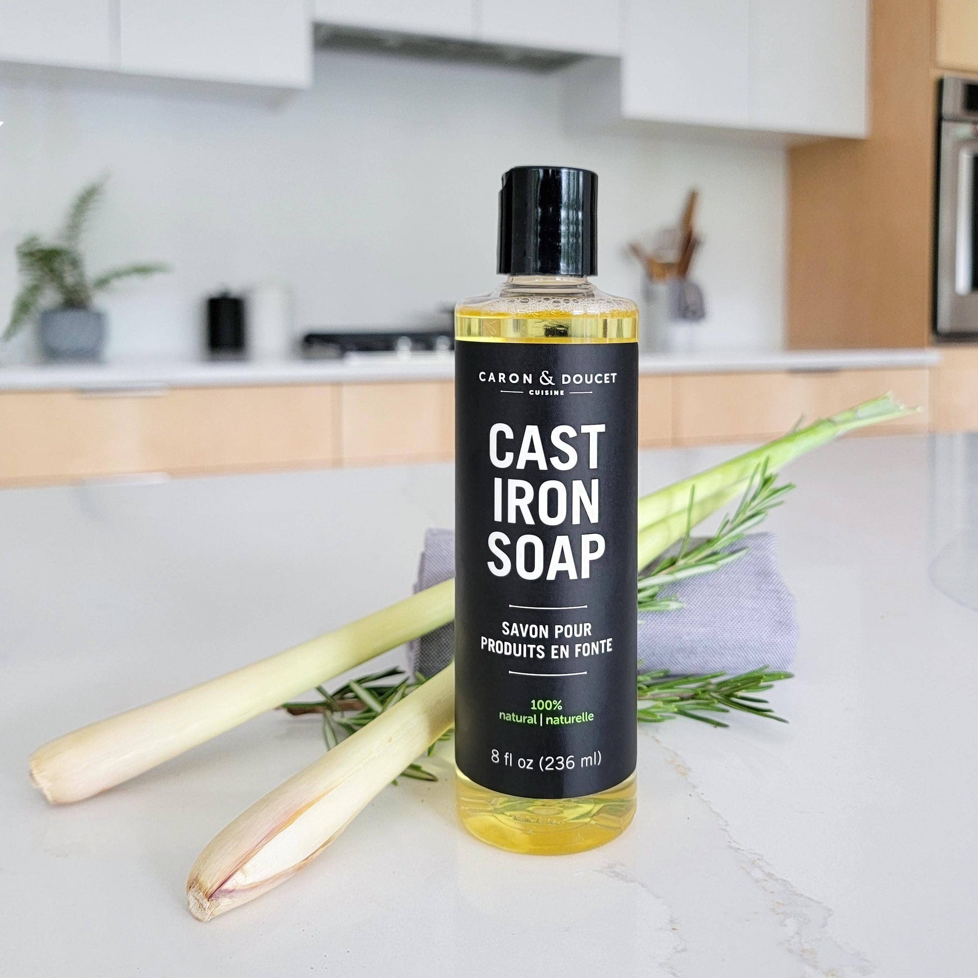 Bottle of Cast Iron Soap on a kitchen counter with greenery