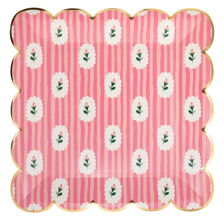 Scalloped-edge paper plate with pink stripes and white floral pattern