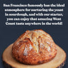 Sourdough bread on a wooden board with promotional text about San Francisco's climate and sourdough.