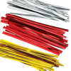 Assorted metallic twist ties in red, gold, and silver on a white background