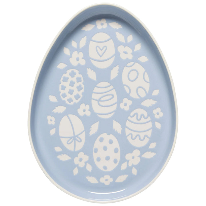 Decorative plate with white egg and floral patterns on a light blue background