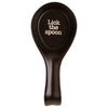 Black spoon rest with 'Lick the spoon' text on a white background