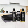 Three bottles of Cast Iron Care products on a kitchen counter with a cast iron skillet.