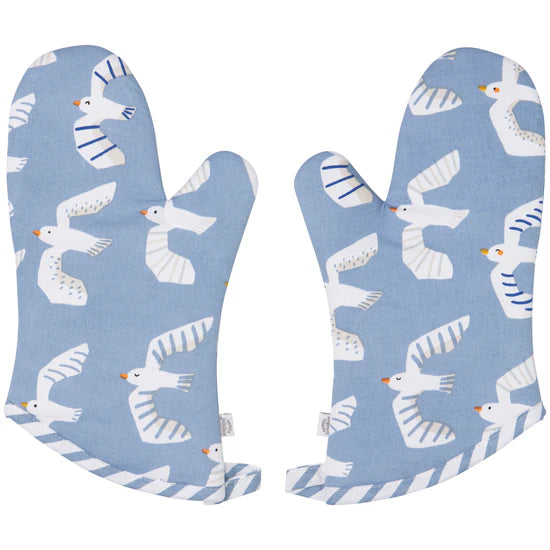 Pair of blue oven mitts with seagull pattern on a white background