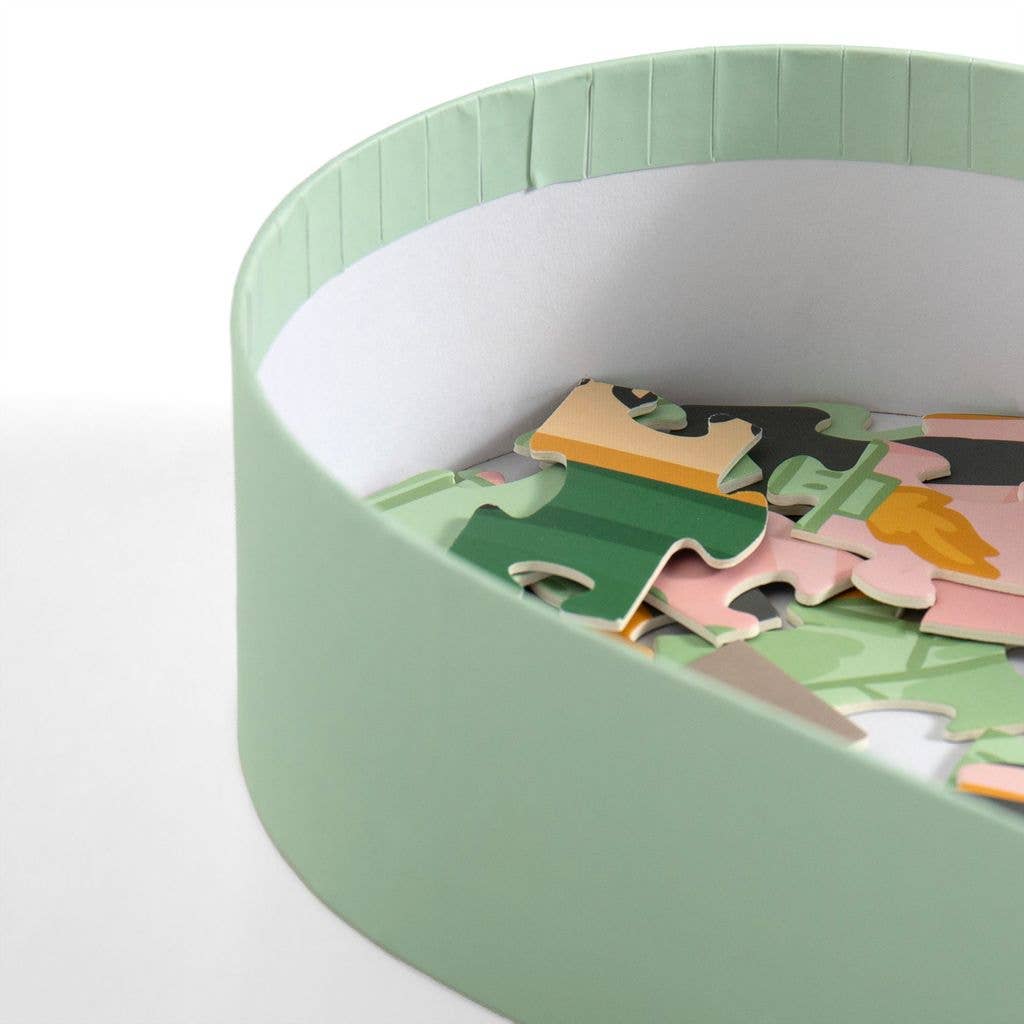 Children's puzzle with colorful pieces in a green and white container