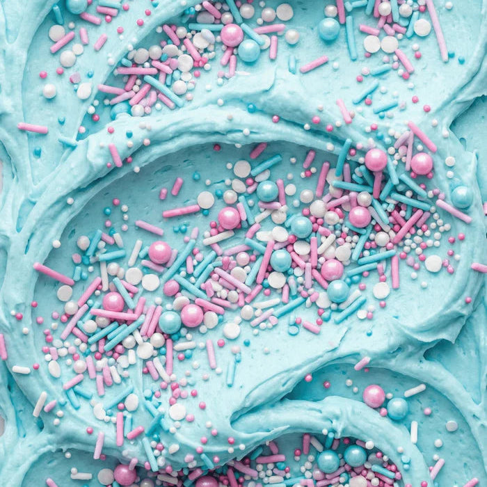 Close-up of blue frosting with pink and blue sprinkles