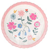 Package of round decorative plates with floral design and pink rim on a white background