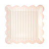 Pink scalloped plate on a white background